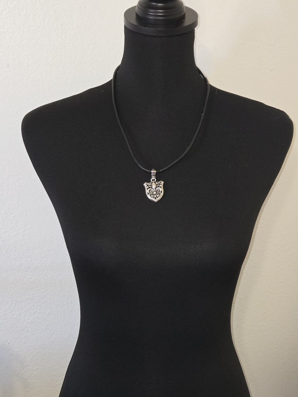Stigma Silver Shield Pendant on Black Cord